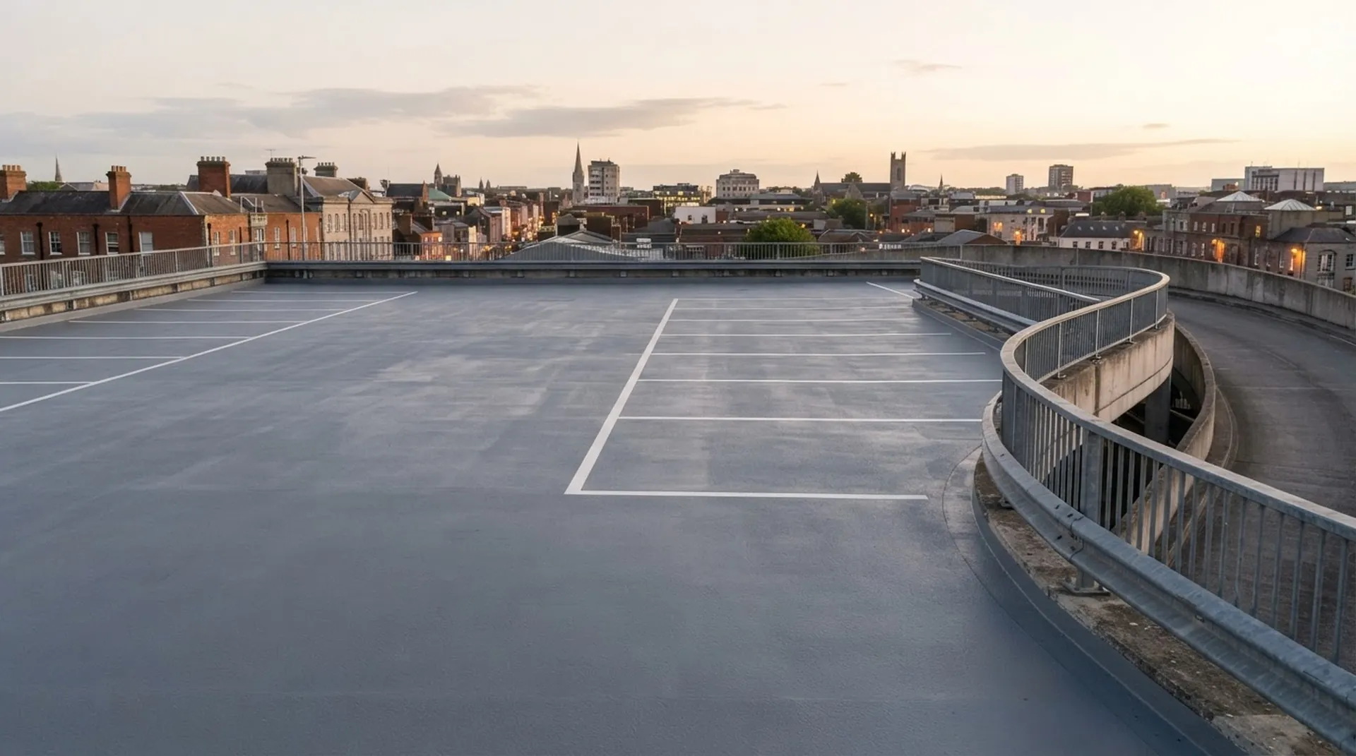 Multi-storey car park deck freshly coated in slate grey with white bays